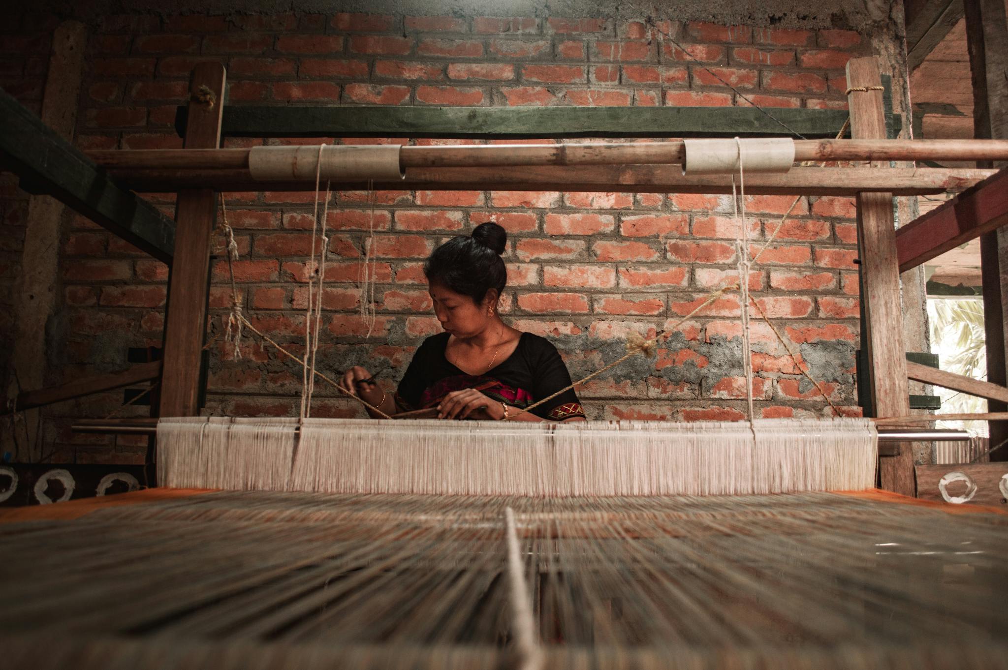 Services 7 a woman sitting near the loom