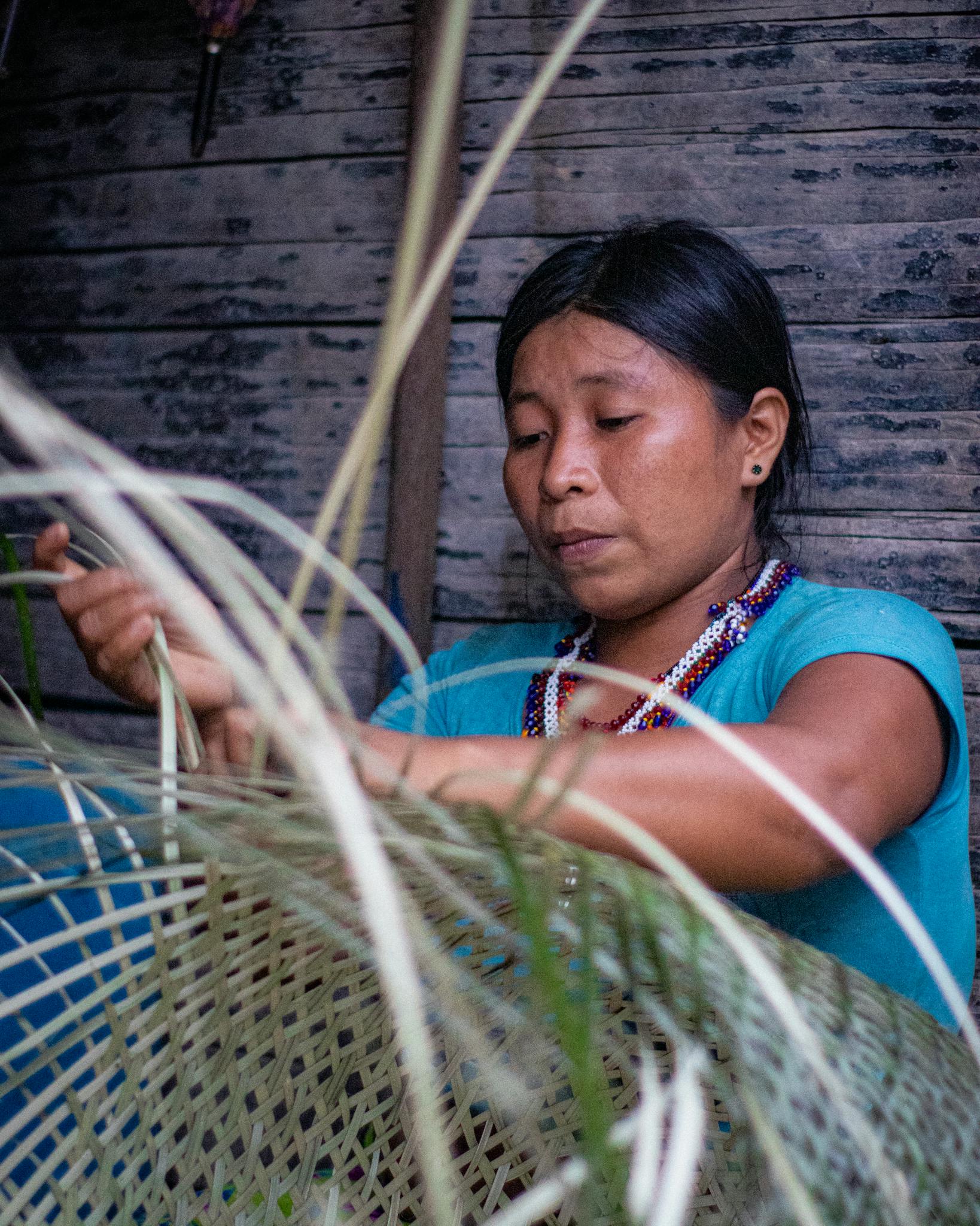 a young woman from colombia skillfully weaves