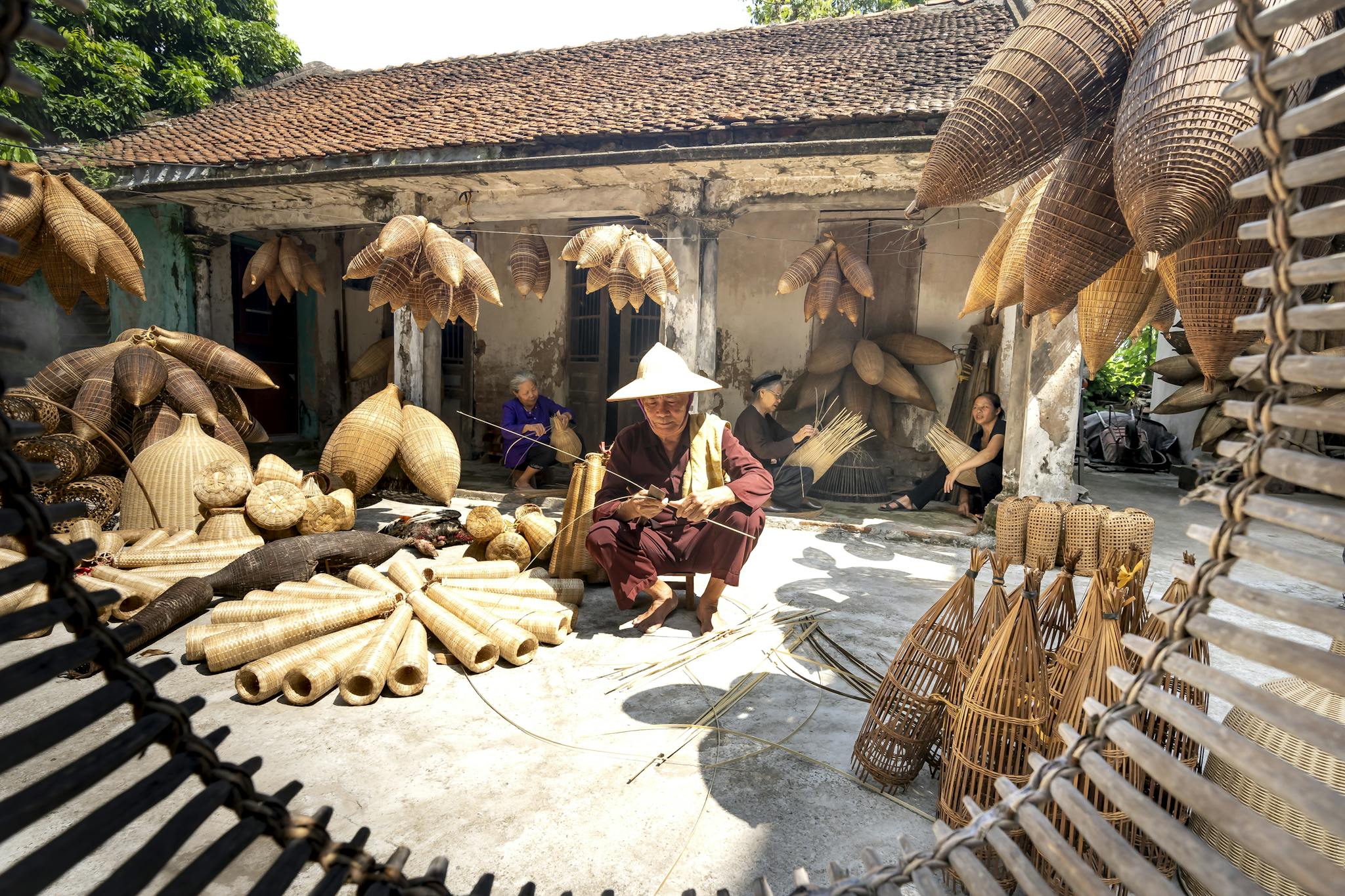 artisans crafting traditional bamboo products in a