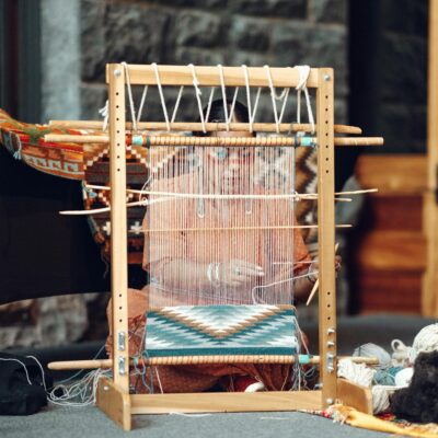 Close-up of a traditional loom in Honolulu showcasing colorful textile weaving.