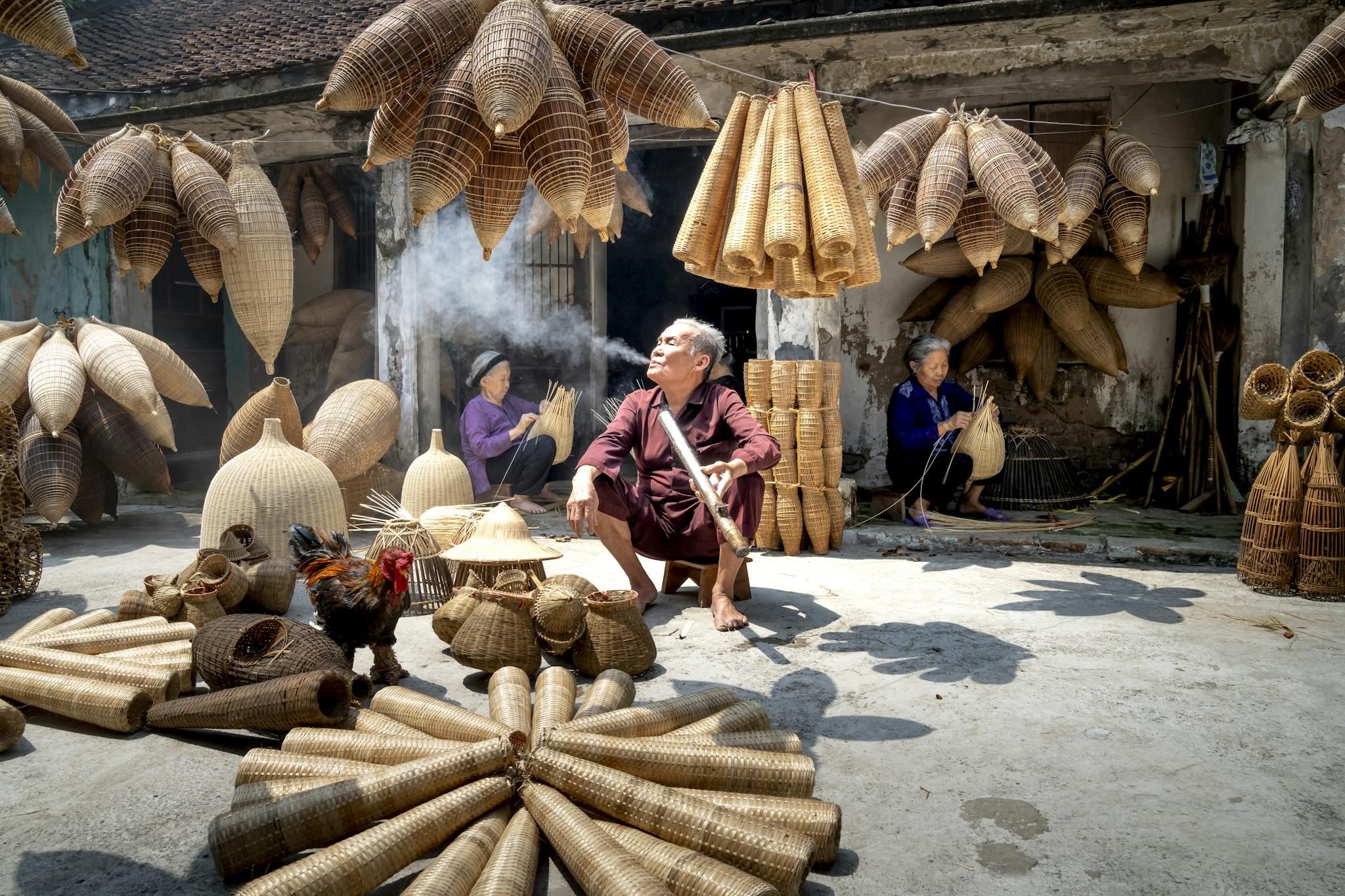 Services 6 elderly vietnamese artisans crafting wicker baskets in