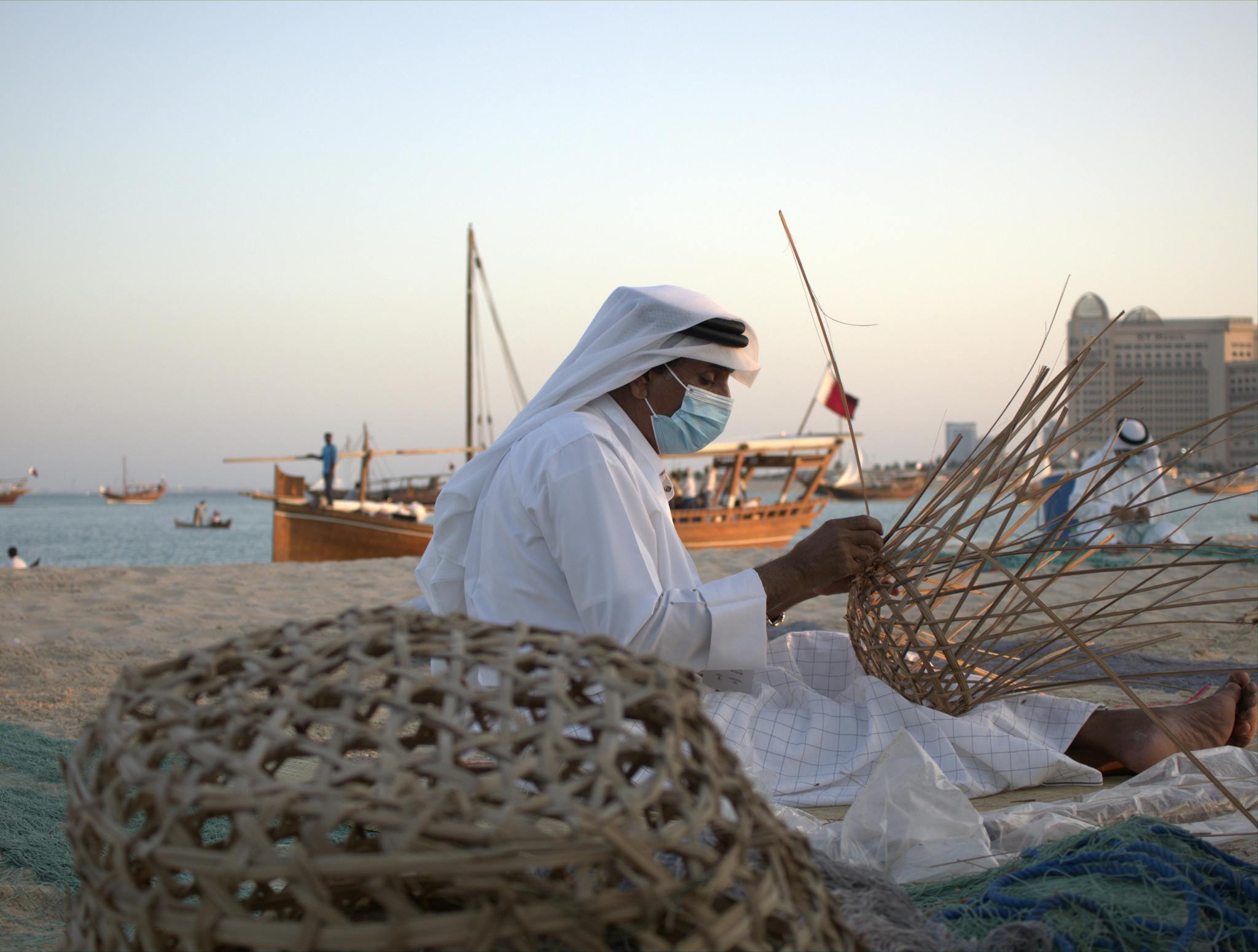 Services 8 man in white thobe making basket