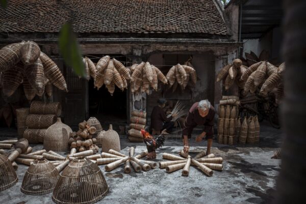 Man with Straw Baskets on a Street